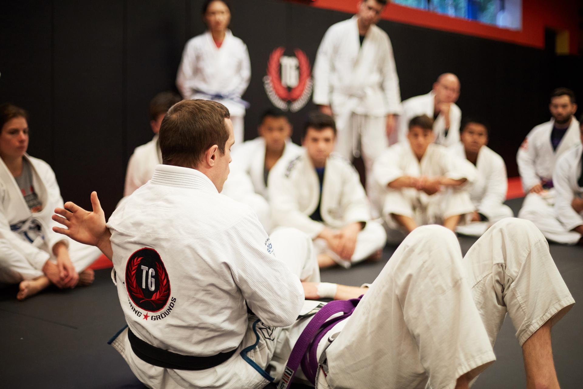 A view inside a martial arts school in bergen county where an instructor is teaching his student how to perform an armbar