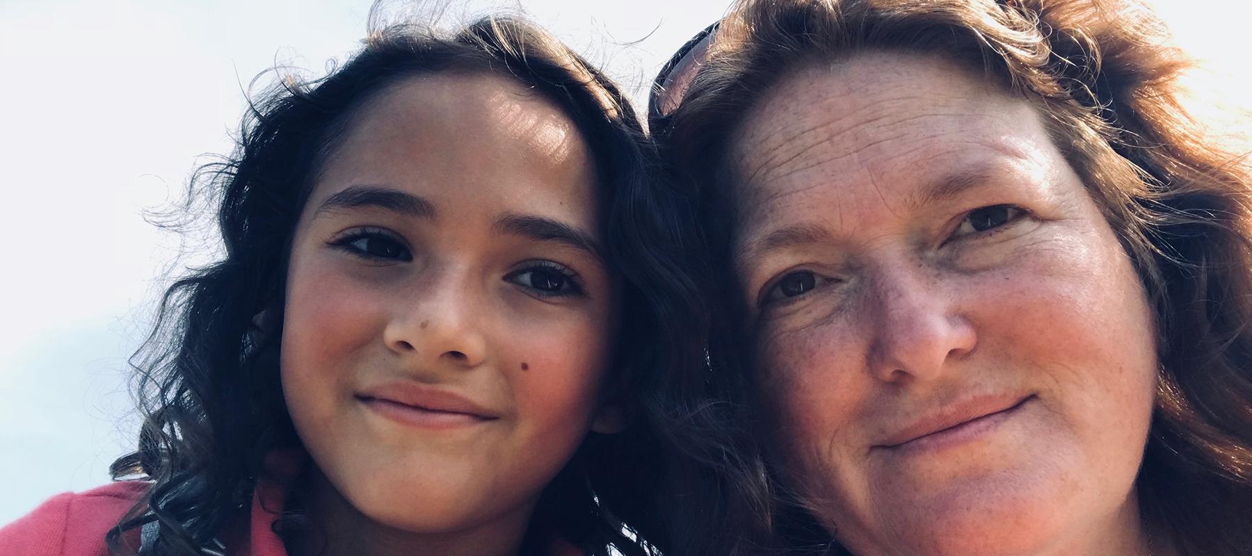 Ellie and her mom meghan smiling outside the gym after taking a kids martial arts class