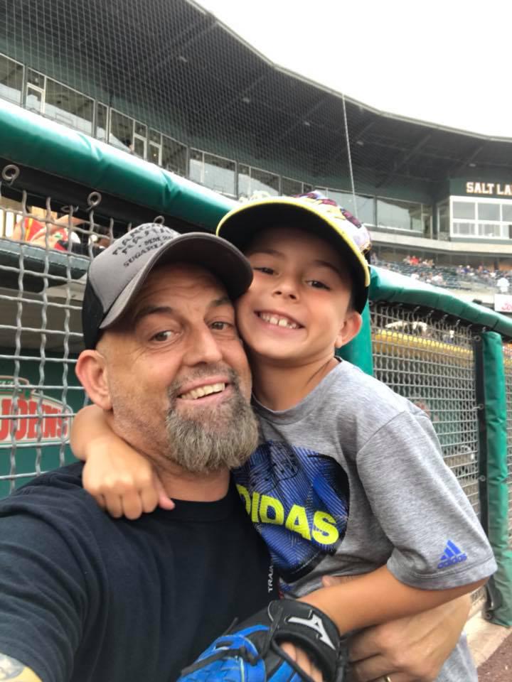 father and son who train smiling after the adults and kids martial arts classes