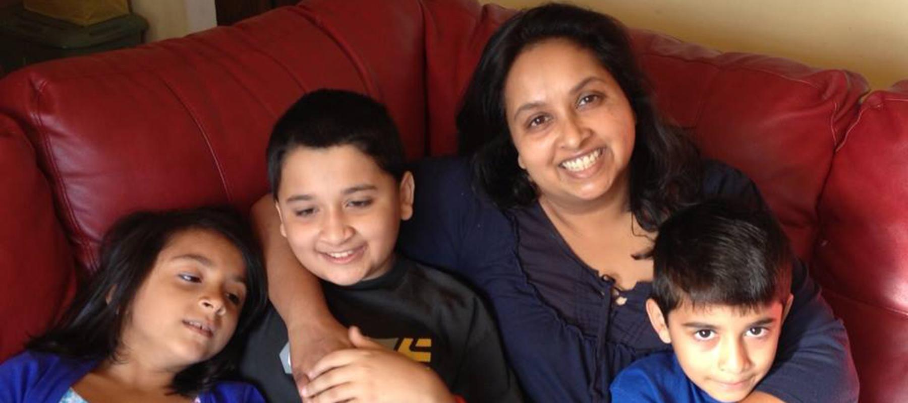 Charmaine and her four children on a couch