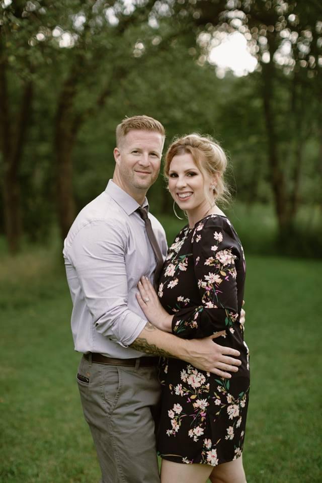 student posing with wife before being interviewed about their experience at training grounds