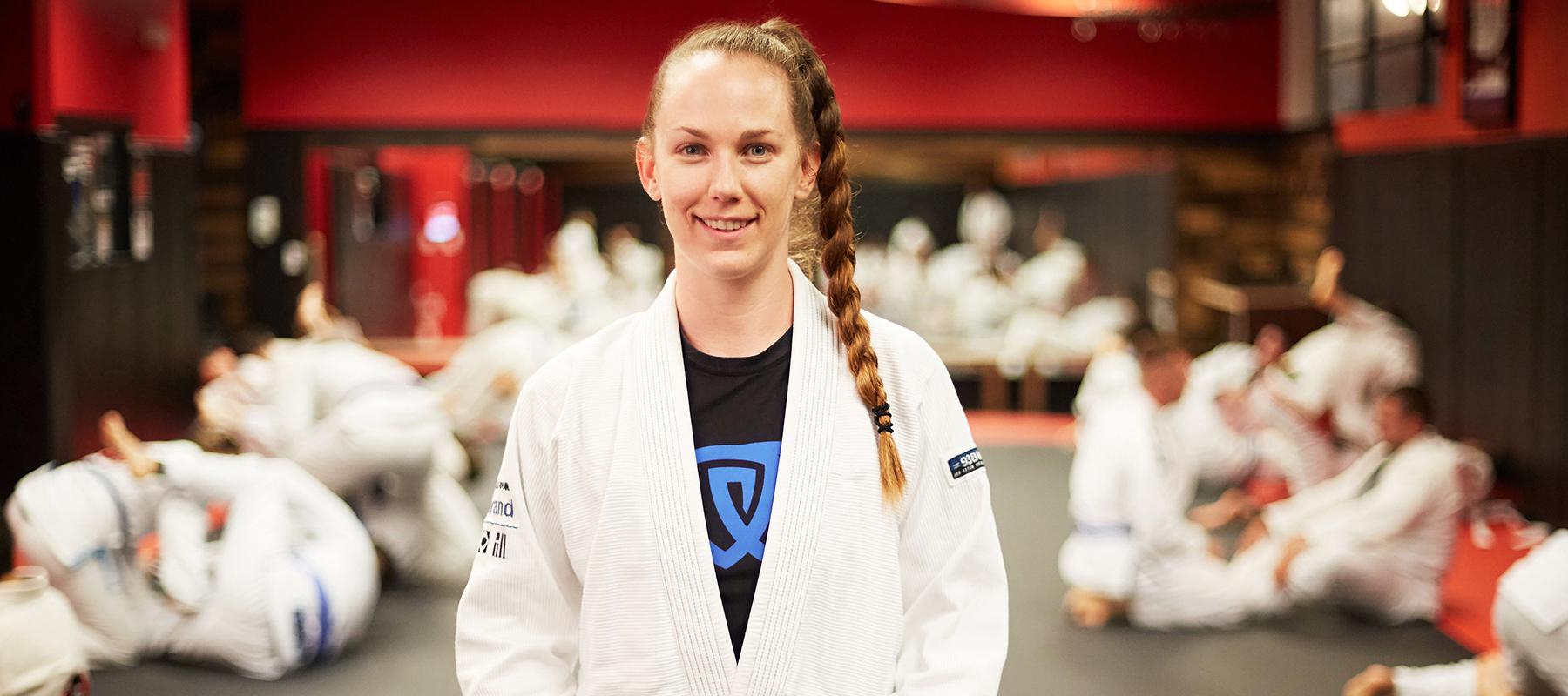 kelly Lynam smiling in her uniform at her bjj class in westwood