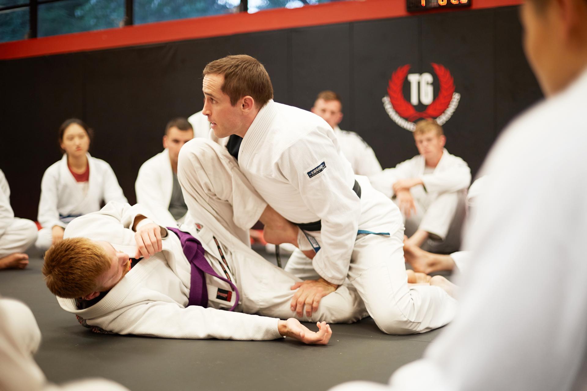 a jiu jitsu instructor teaching a guard pass