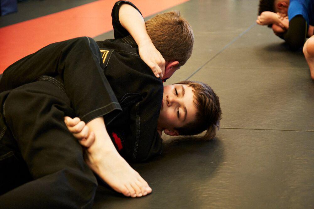 kids drilling the move in jiu jitsu class at training grounds